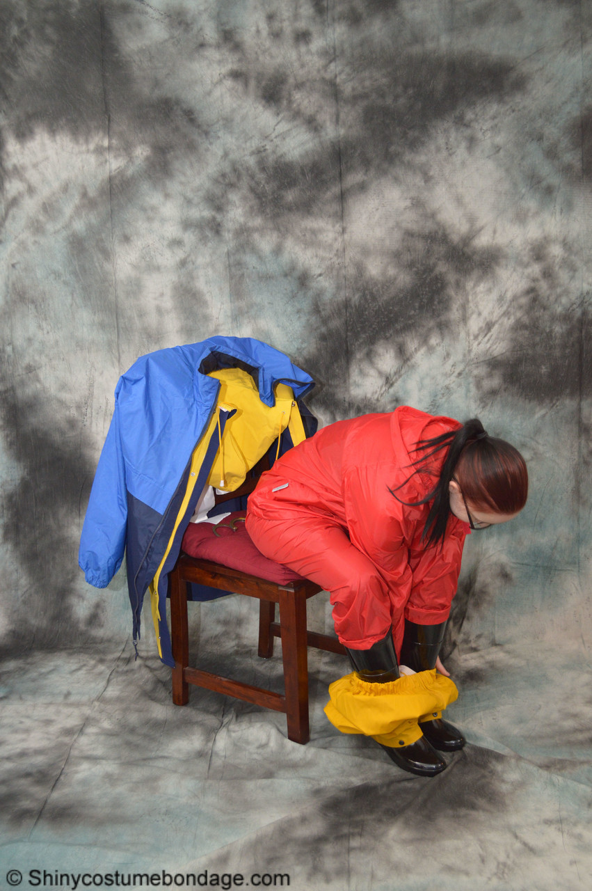 16P Pale redhead Lady Nadja dons a cleave gag while wearing rain suits