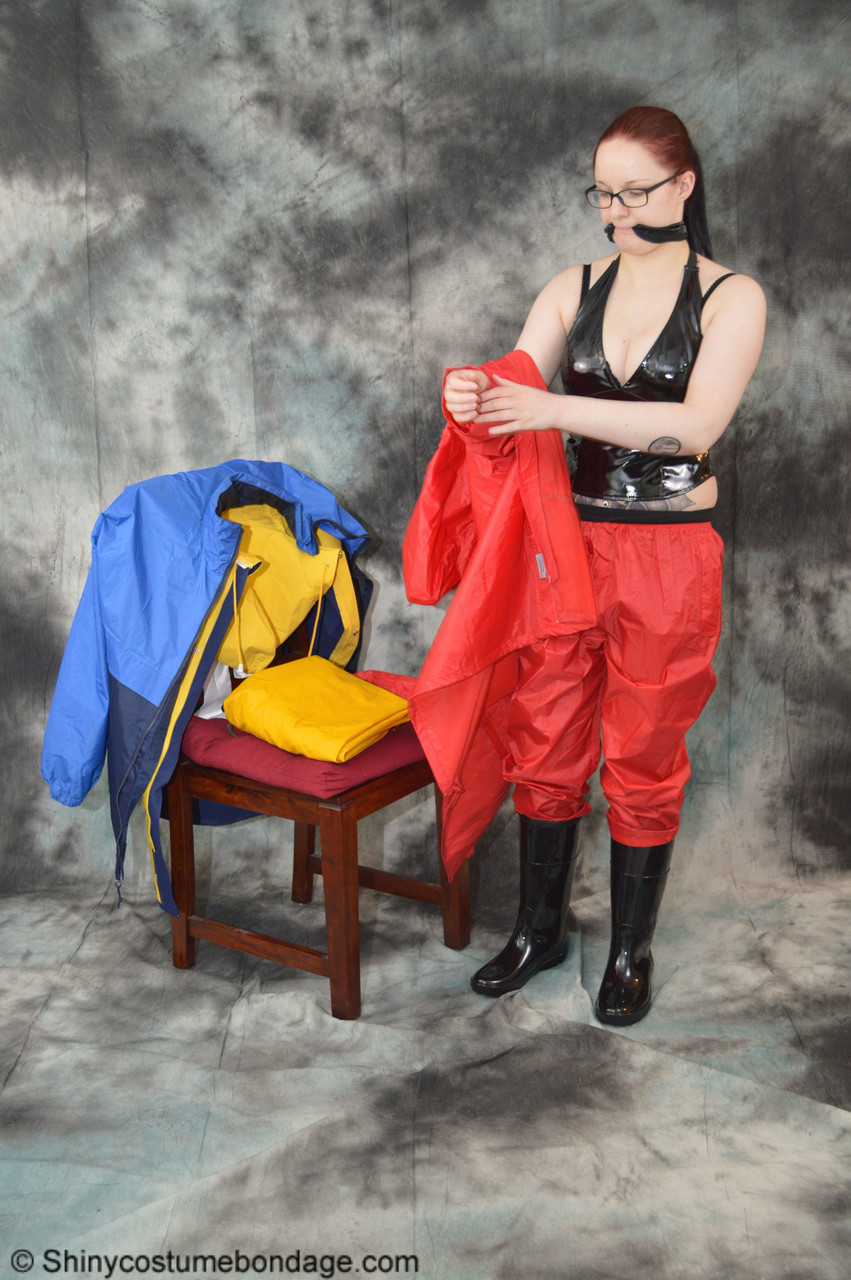16P Pale redhead Lady Nadja dons a cleave gag while wearing rain suits