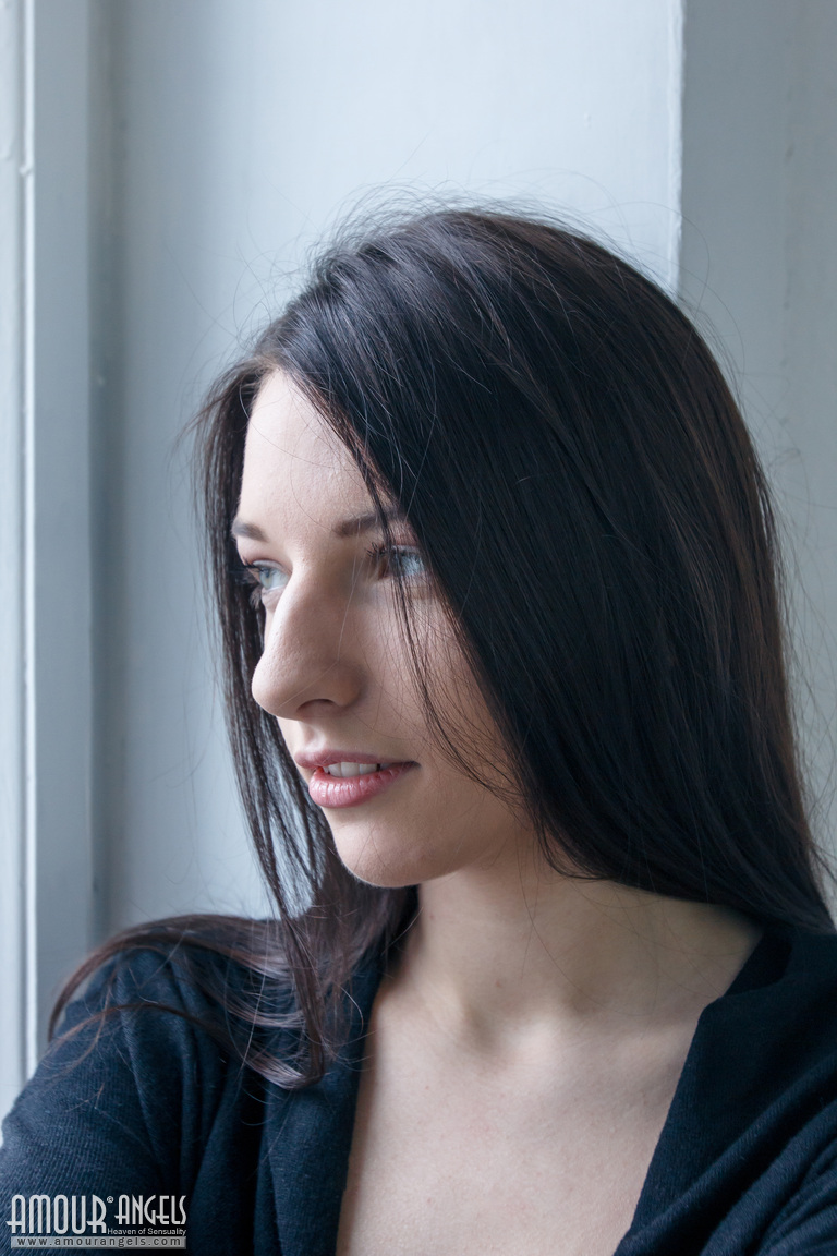 20P Dark haired teen girl strips to black over the knee socks in the window sill