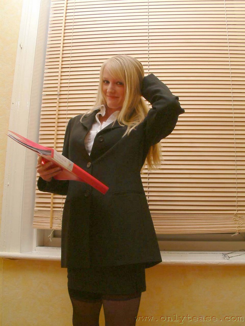 21P Skinny office doll Sharon strips by the window and poses in lingerie