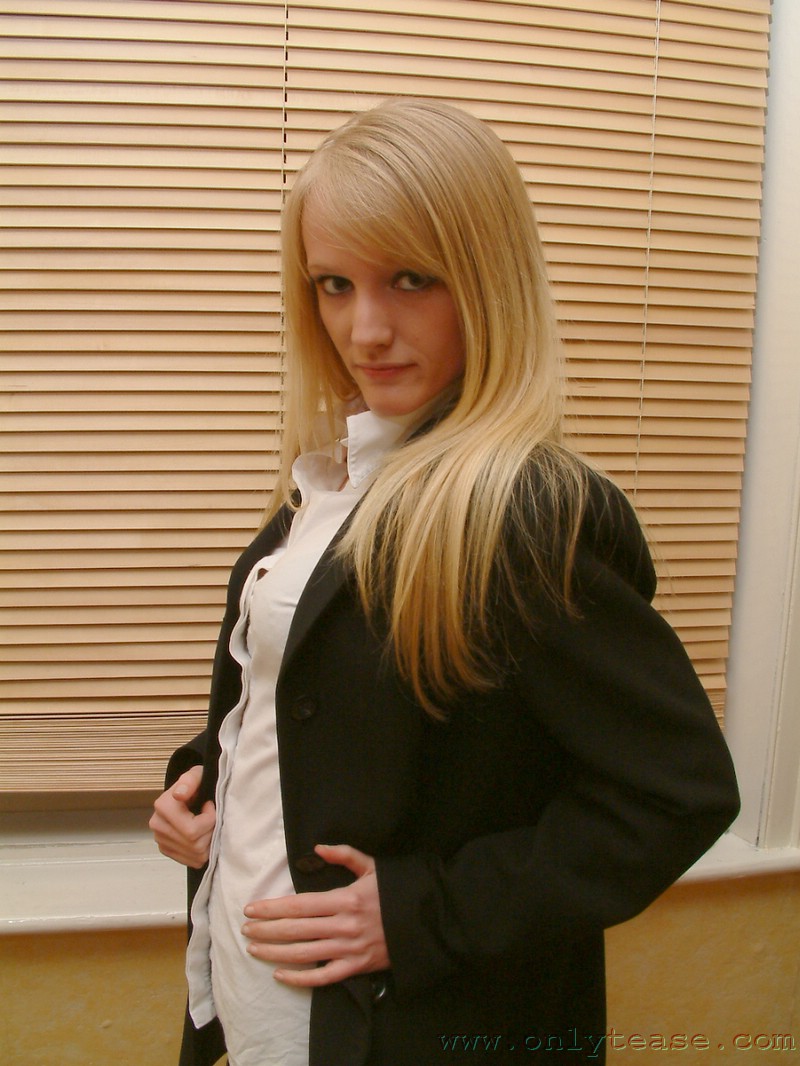 21P Skinny office doll Sharon strips by the window and poses in lingerie