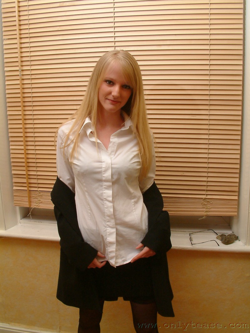 21P Skinny office doll Sharon strips by the window and poses in lingerie