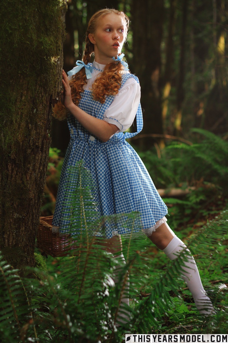 15P Charming redhead teen Dolly Little gets naked in white socks while in a forest