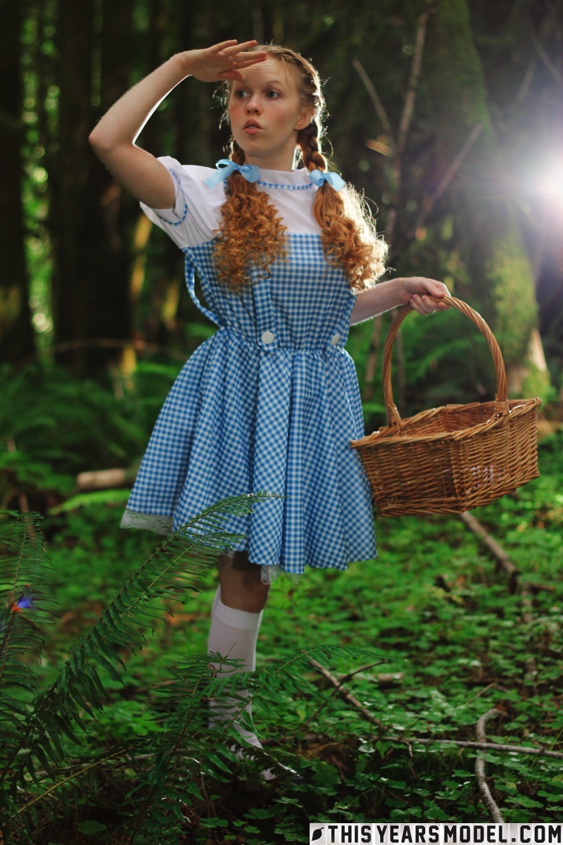 15P Charming redhead teen Dolly Little gets naked in white socks while in a forest