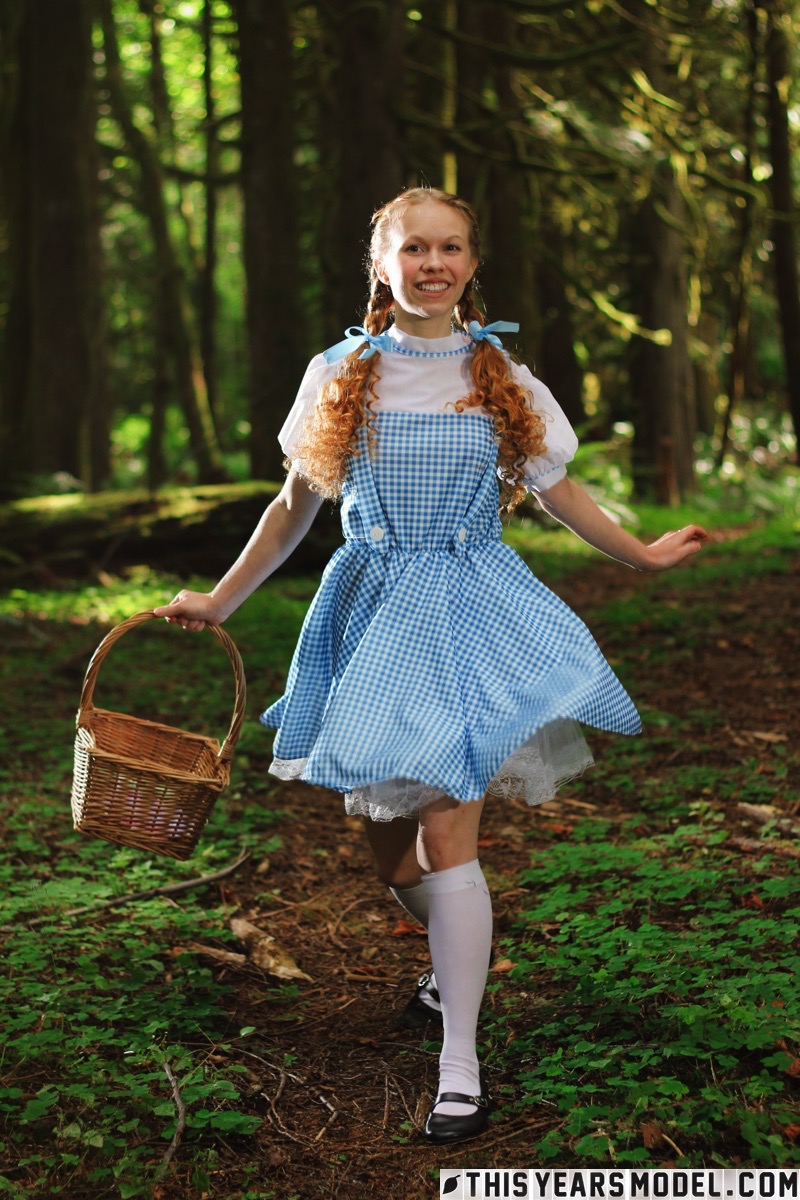 15P Charming redhead teen Dolly Little gets naked in white socks while in a forest