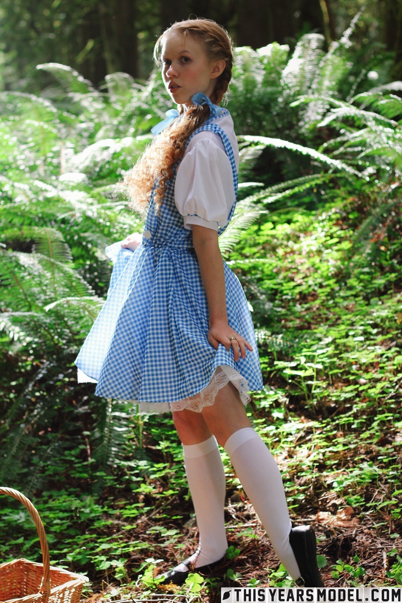15P Charming redhead teen Dolly Little gets naked in white socks while in a forest