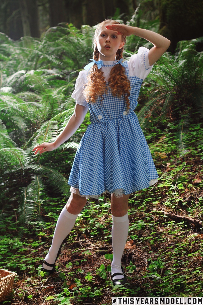 15P Charming redhead teen Dolly Little gets naked in white socks while in a forest