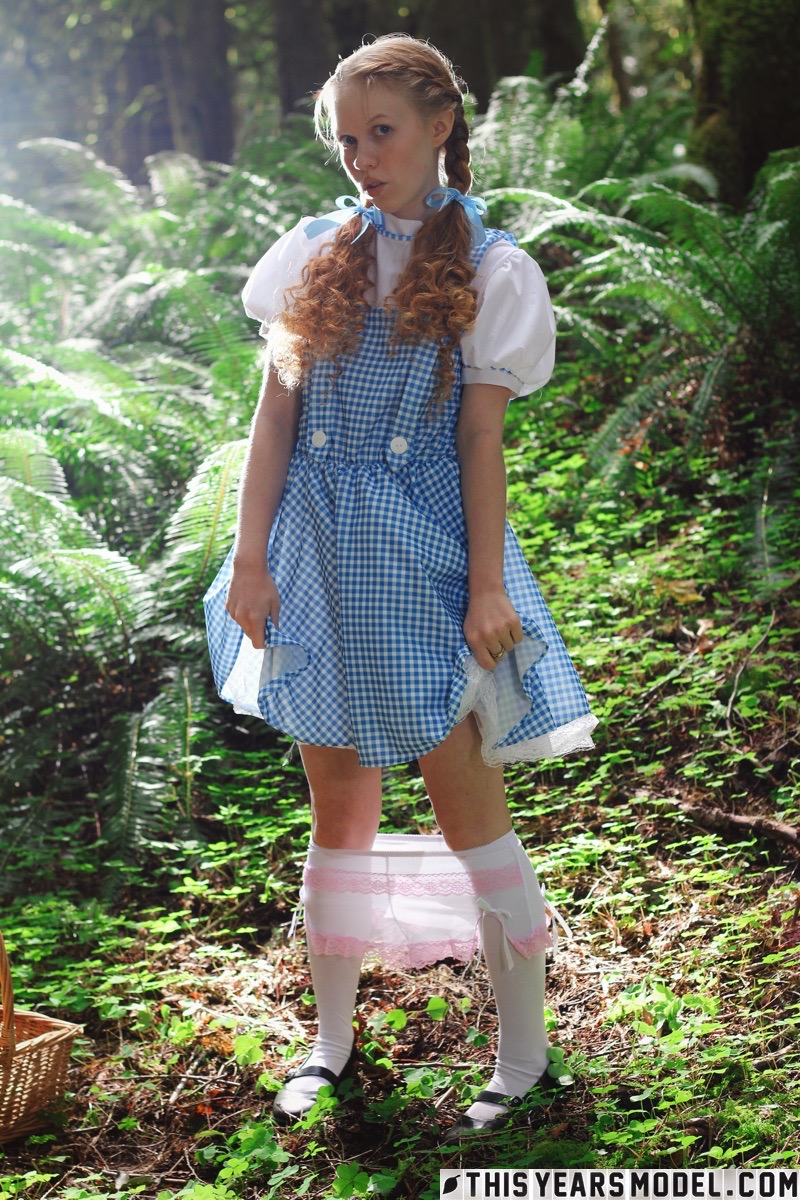 15P Charming redhead teen Dolly Little gets naked in white socks while in a forest
