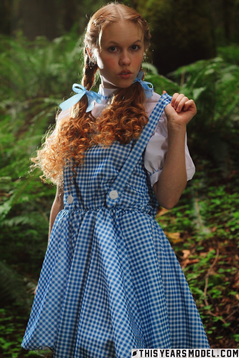 15P Charming redhead teen Dolly Little gets naked in white socks while in a forest