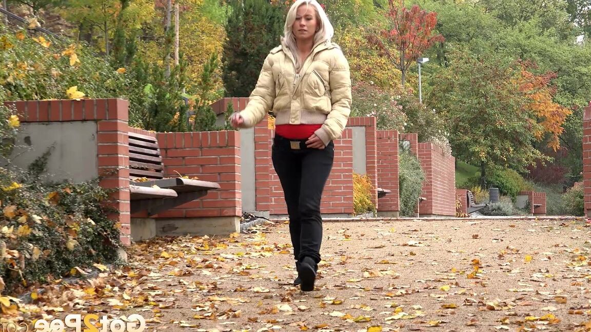 15P Clothed blonde Licky Lex pulls down dark leggings for a piss by a public bench