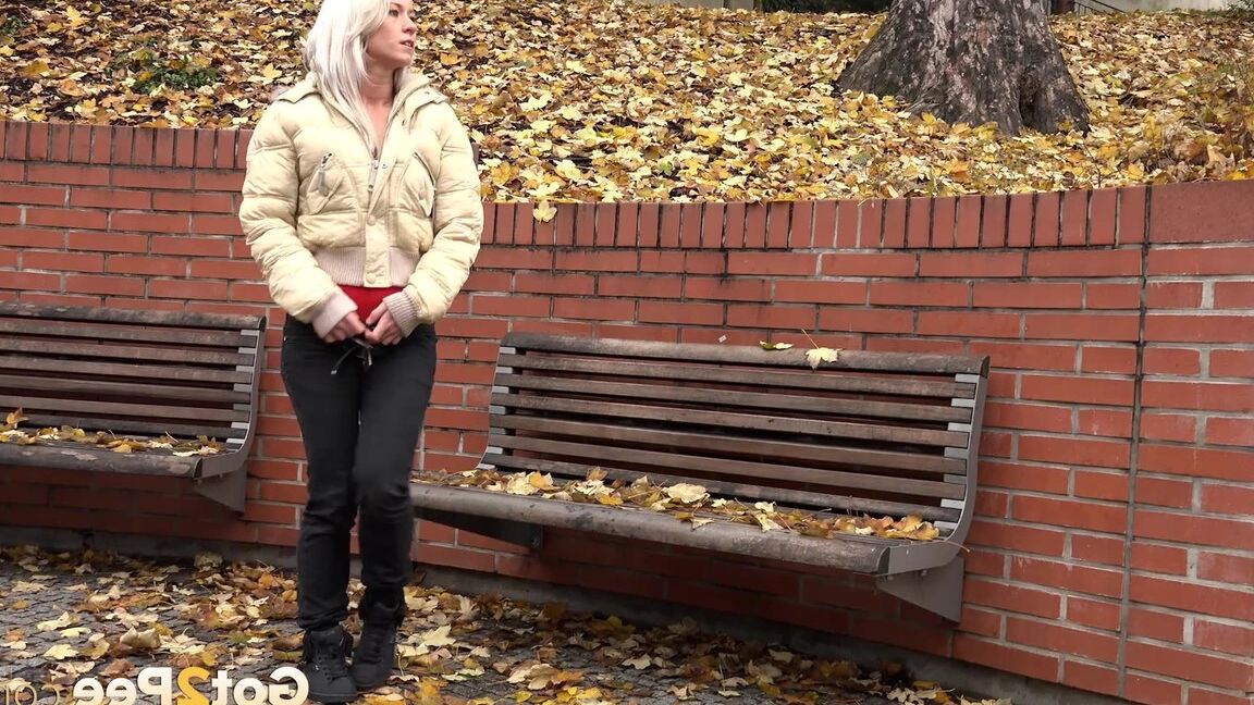 15P Clothed blonde Licky Lex pulls down dark leggings for a piss by a public bench
