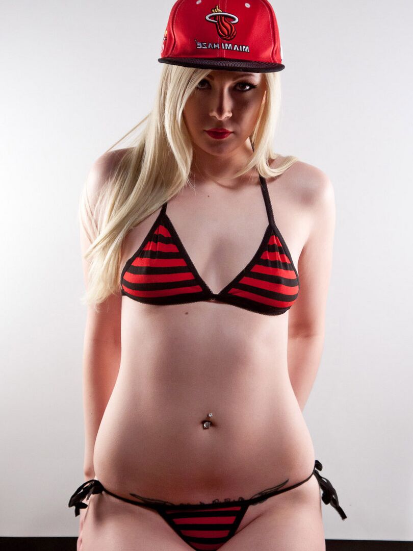 16P Young blonde Sabrina Sins doffs a bikini to pose nude in a ballcap & OTK socks