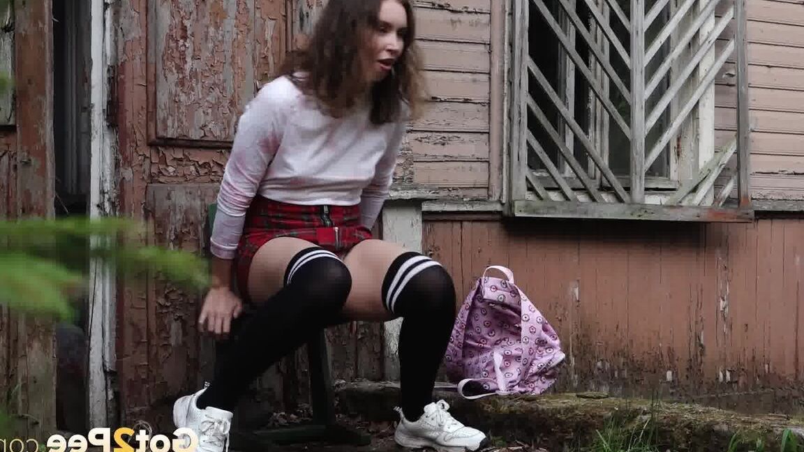 15P Brunette babe pees outside an old building