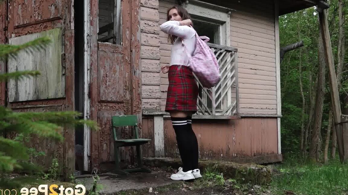 15P Brunette babe pees outside an old building