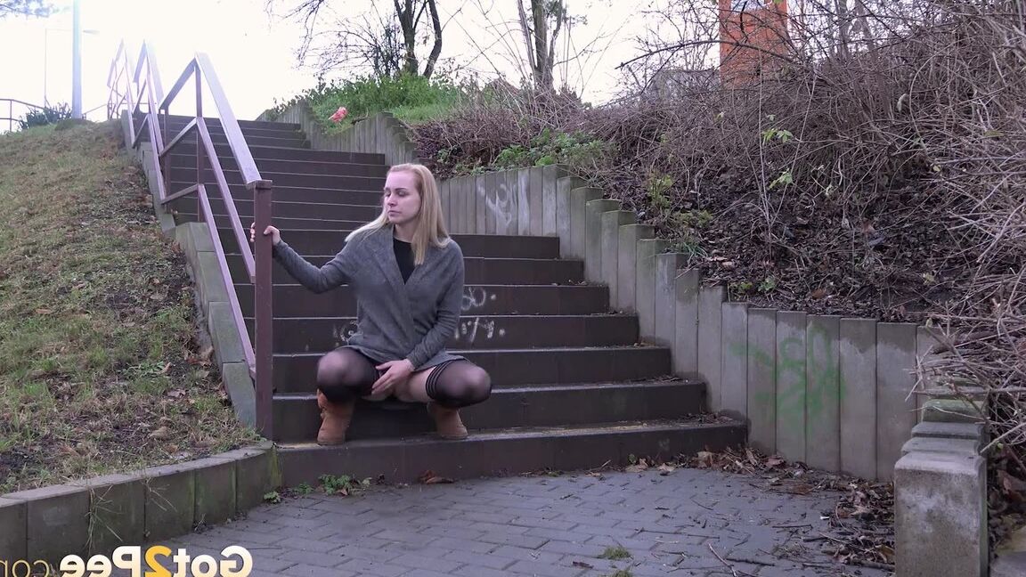 15P Pretty blonde pisses over steps in the city