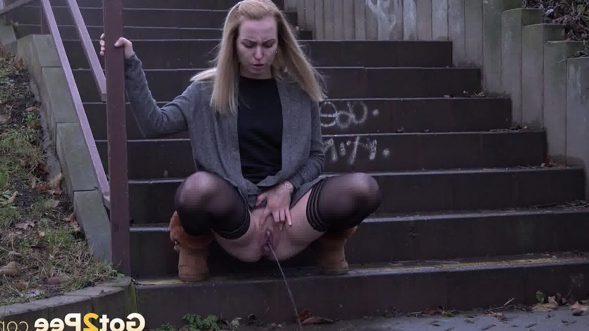 15P Pretty blonde pisses over steps in the city