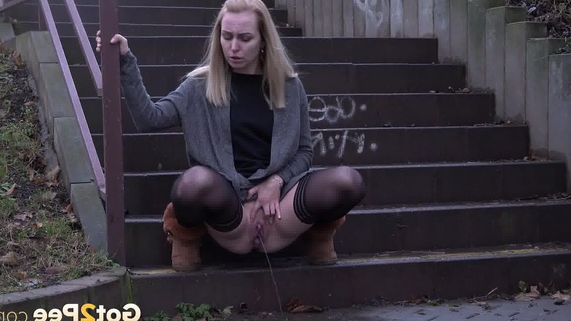 15P Pretty blonde pisses over steps in the city