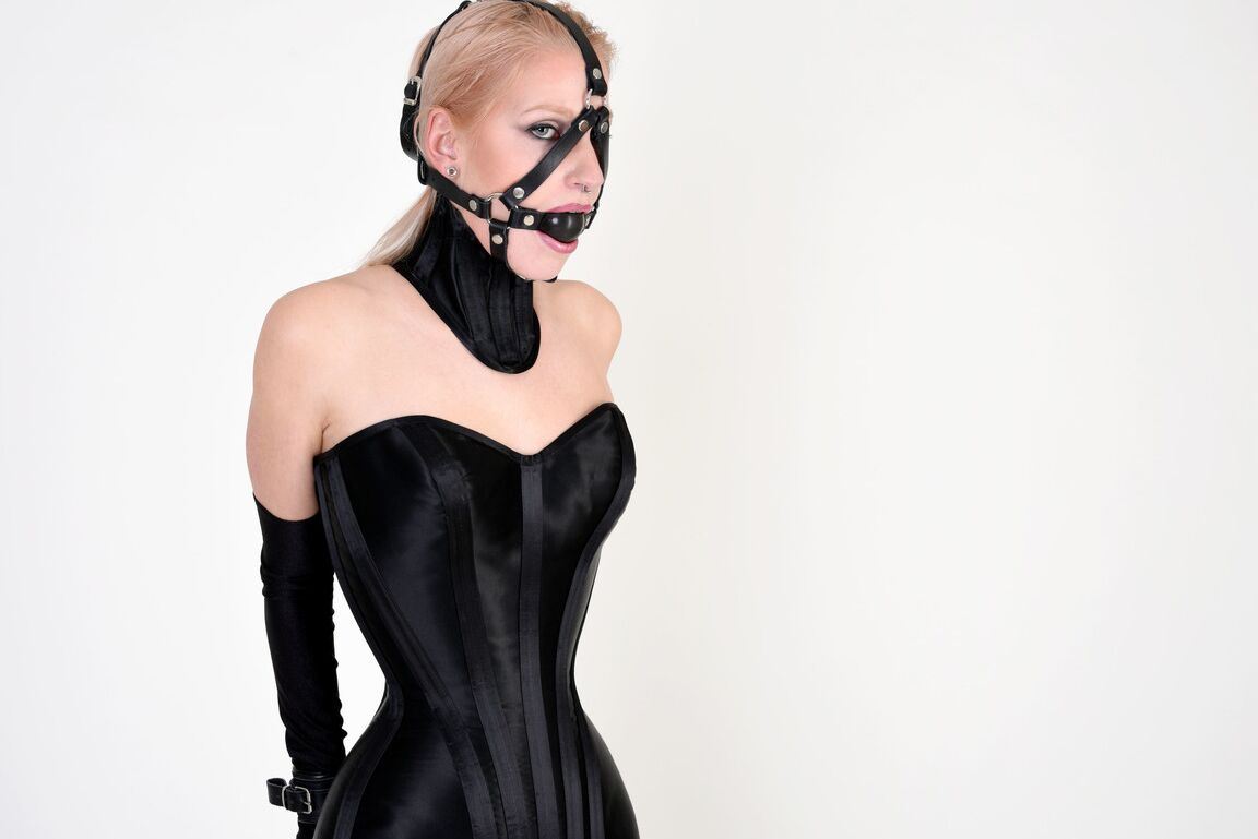 16P Fair-skinned blonde is fitted with a gag while wearing a hobble dress