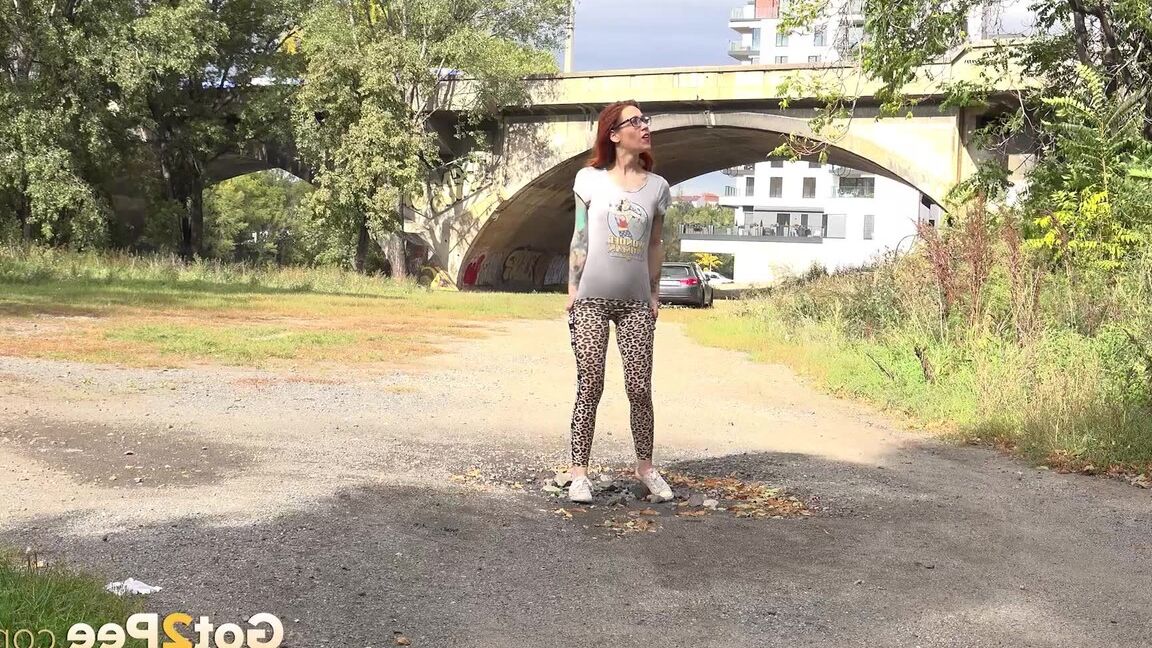 15P Hot redhead in leopard print pees outside