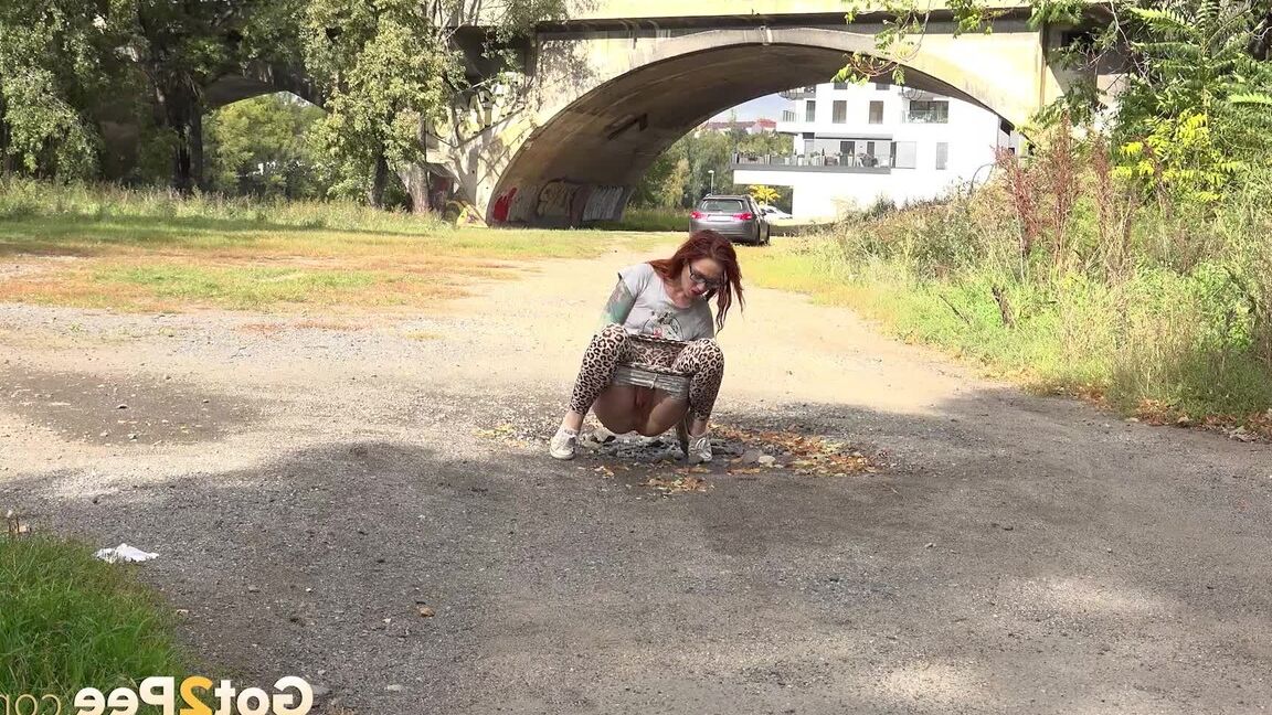 15P Hot redhead in leopard print pees outside