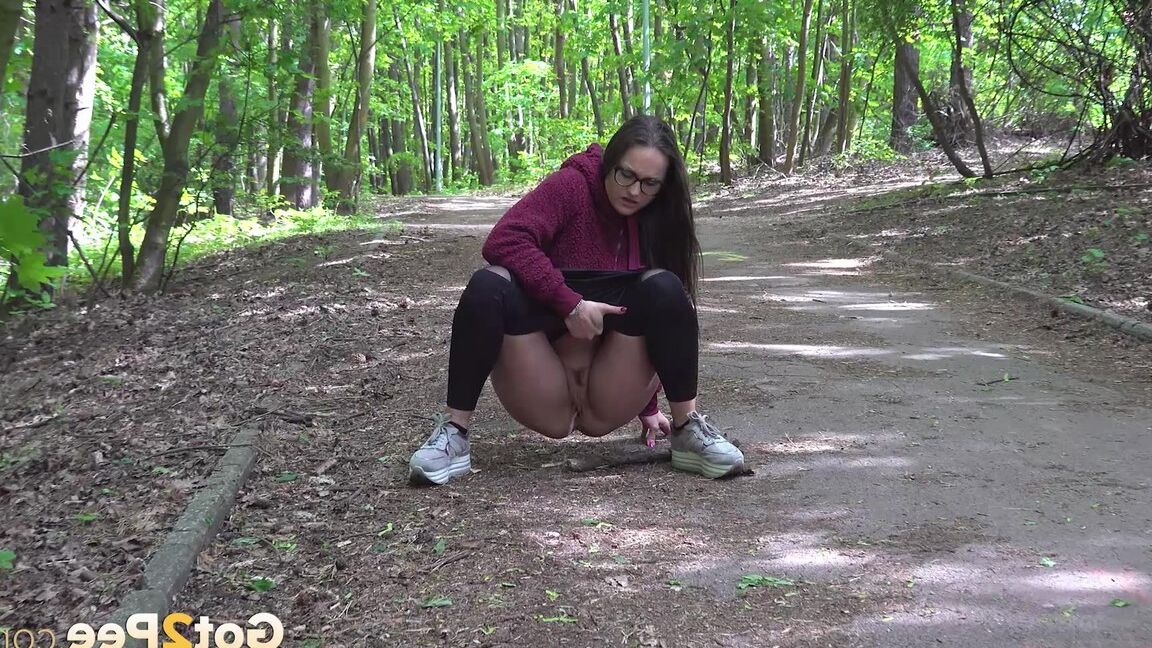 15P Gorgeous dark haired babe squats and pees outside