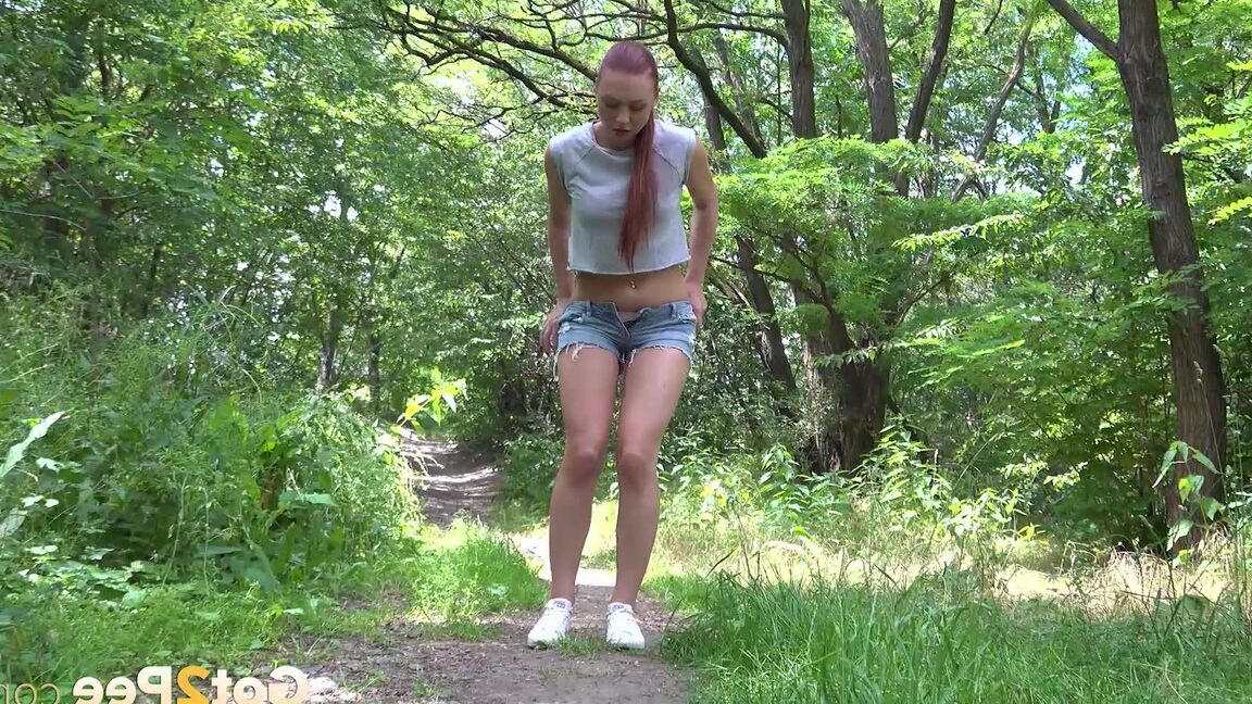 15P Gorgeous redhead Morgan squats to pees outside