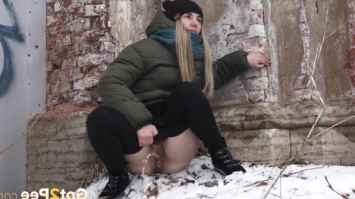 15P Blonde sits in the snow and relieves herself