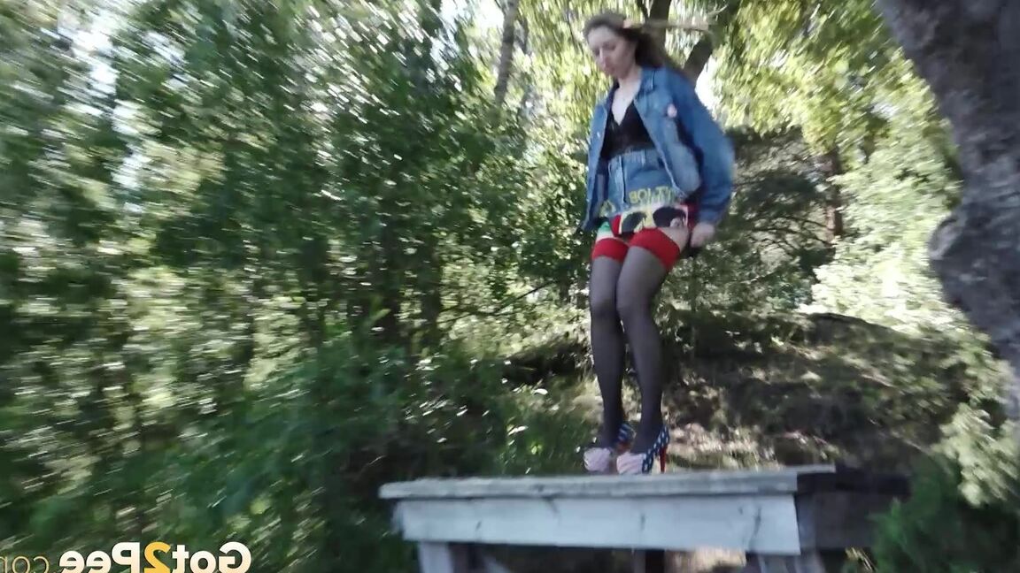 15P Cute brunette pees off the end of a jetty outside