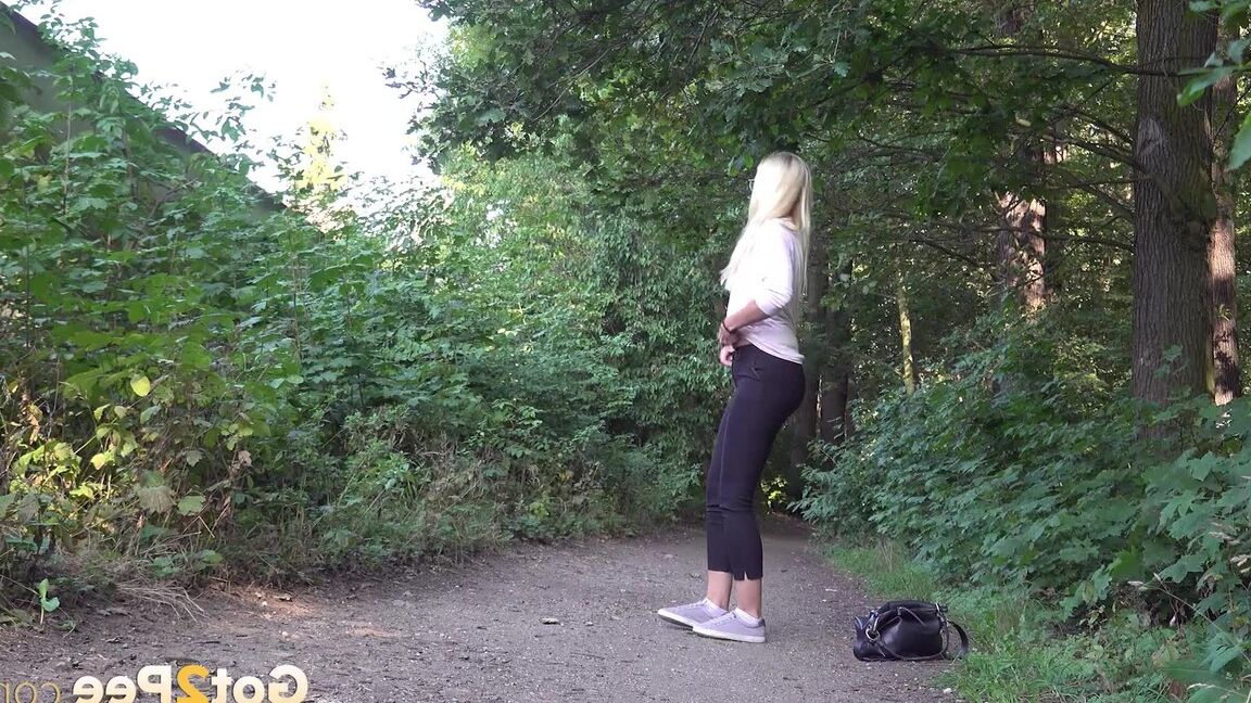 15P Pretty blonde Delphine relieves herself outside