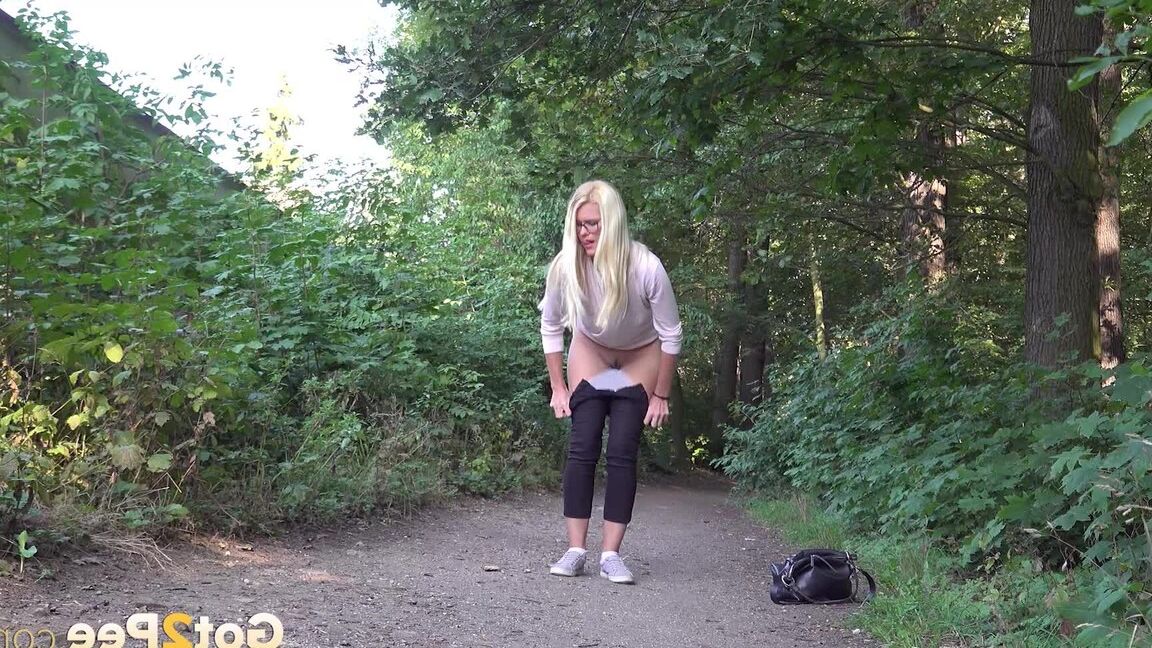 15P Pretty blonde Delphine relieves herself outside