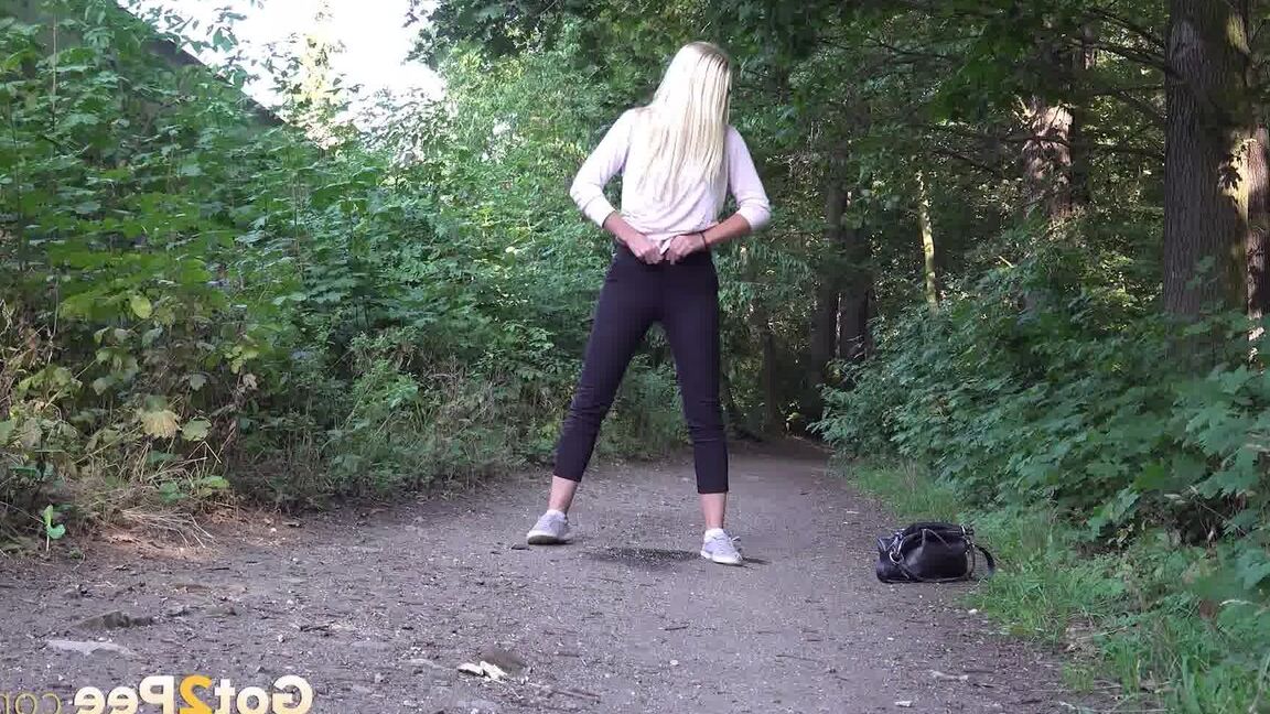 15P Pretty blonde Delphine relieves herself outside