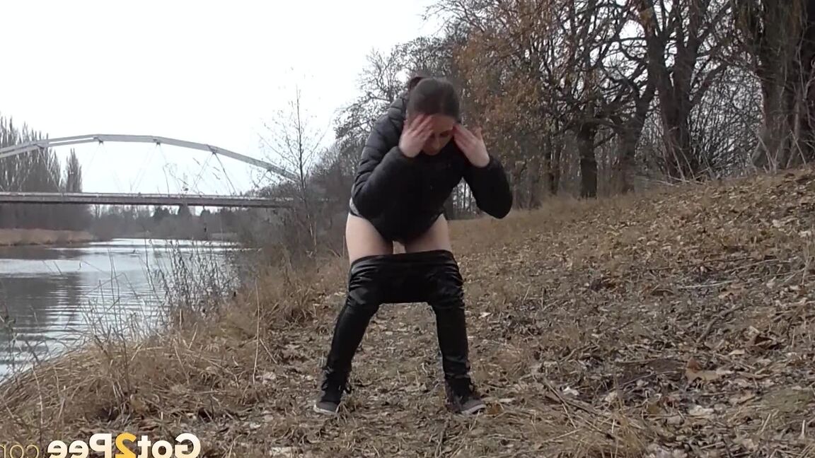 15P Antonia Sainz squats and pees near the river