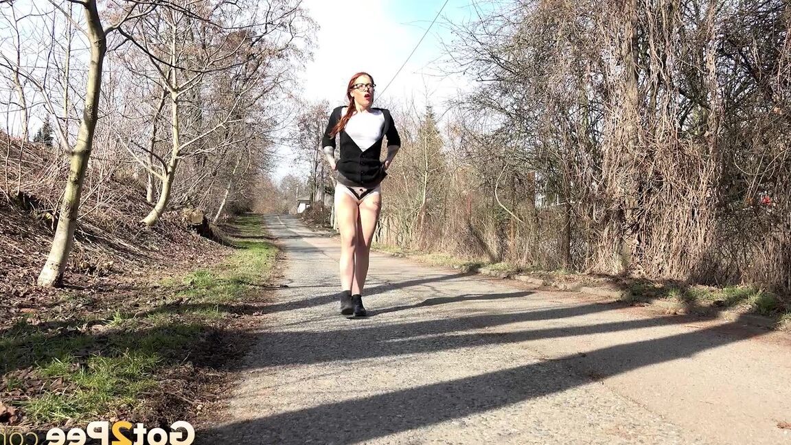 15P Gorgeous redhead pees in the middle of road