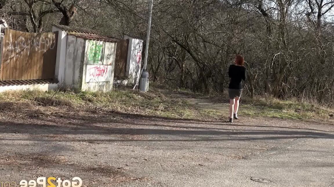 15P Gorgeous redhead pees in the middle of road