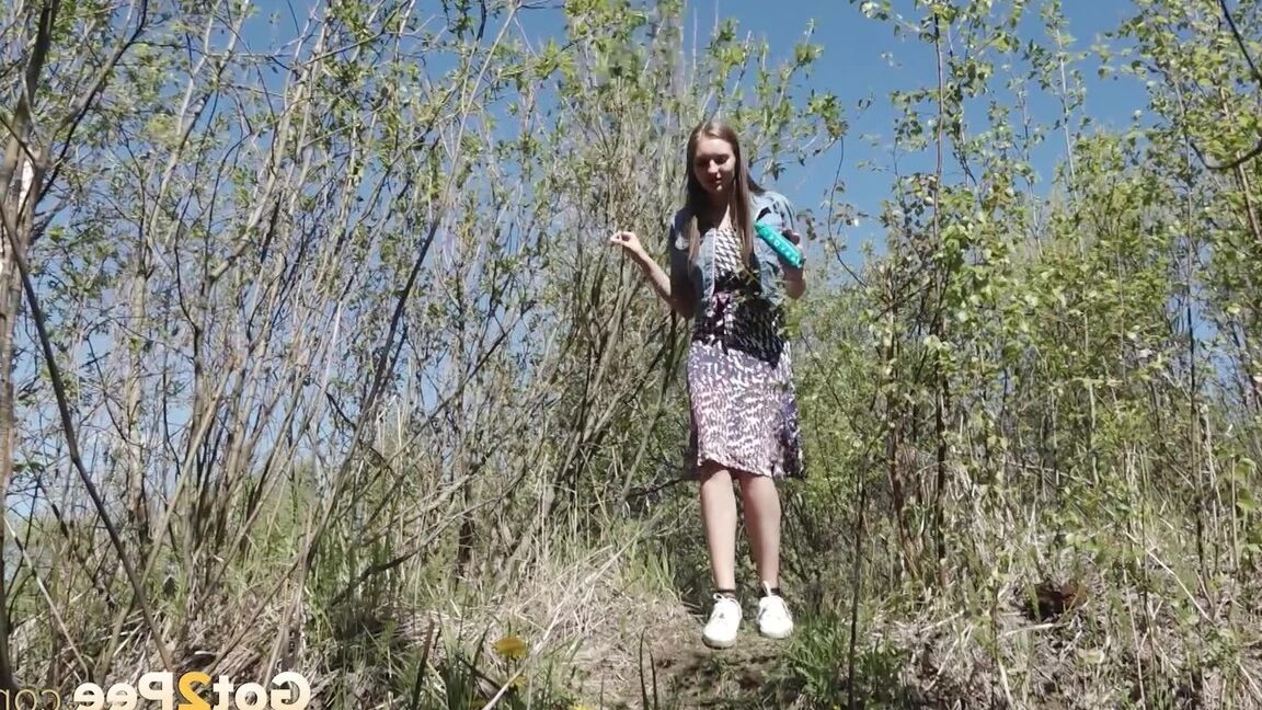 15P Distressed girl Viktoria takes a badly needed piss on a bank in the outdoors