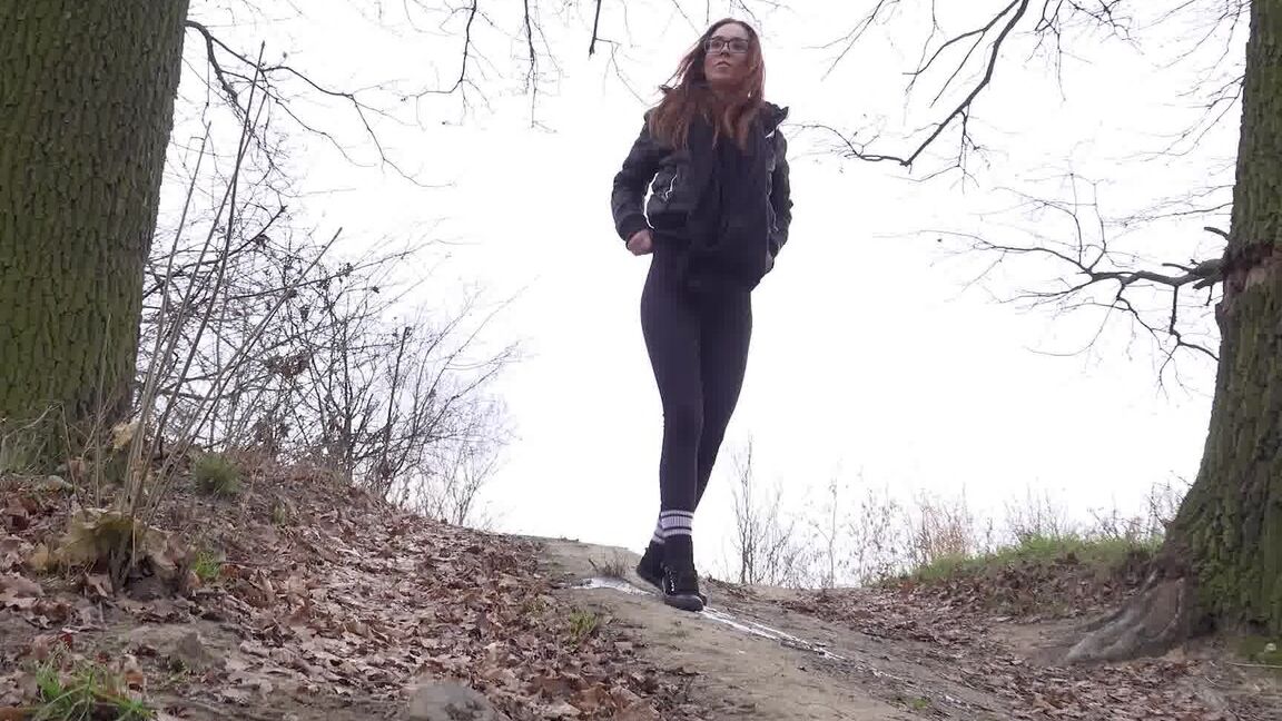 15P Redhead in glasses pees on a slope in the country