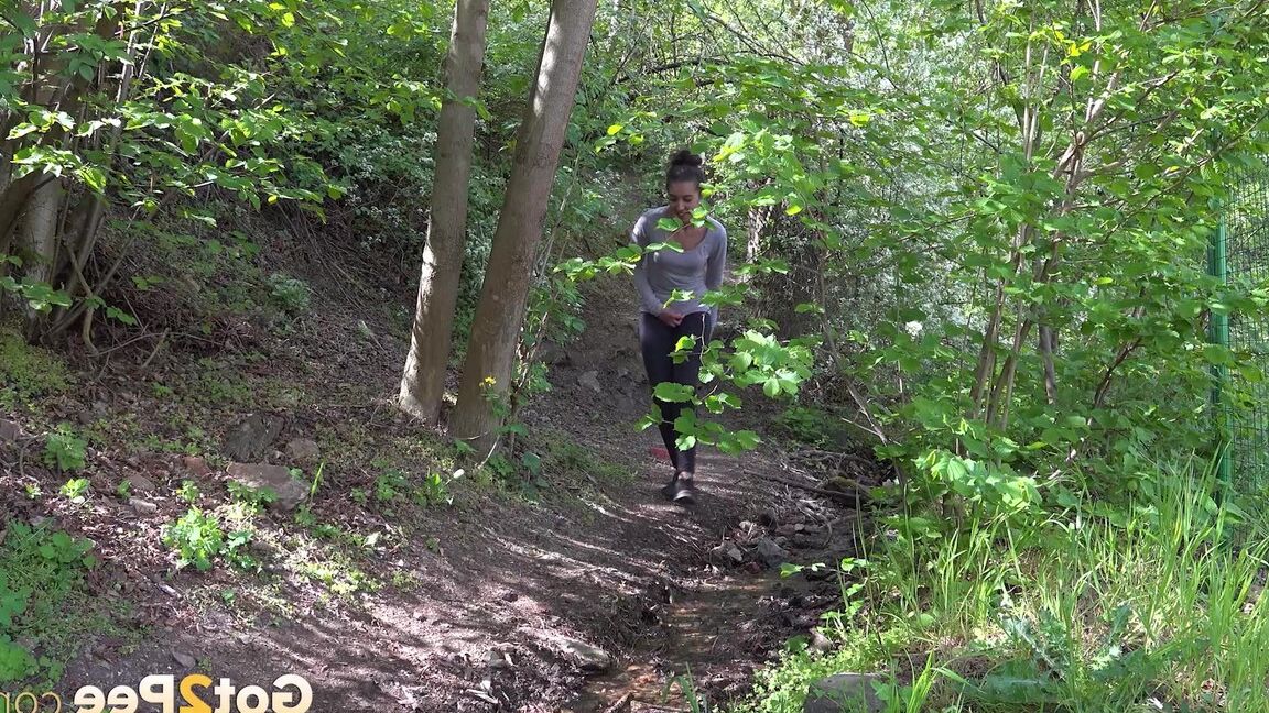 15P Dark haired Esperansa pees into a woodland stream