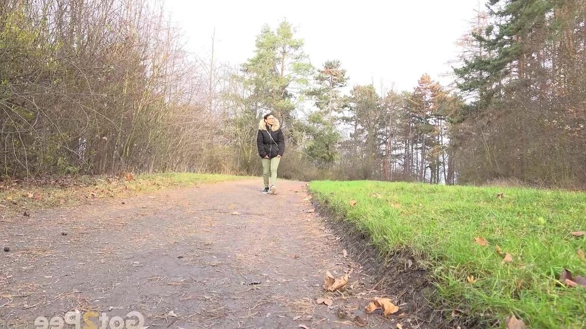 15P Clothed female Natasha Ink holds down her pants for a piss on a rural road