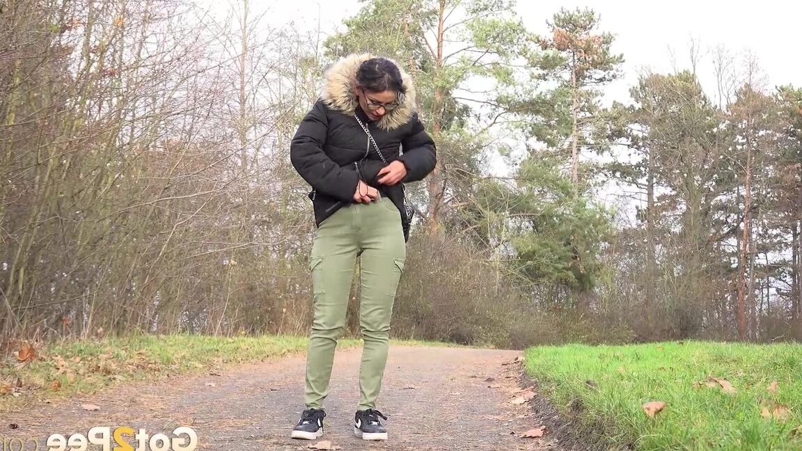 15P Clothed female Natasha Ink holds down her pants for a piss on a rural road