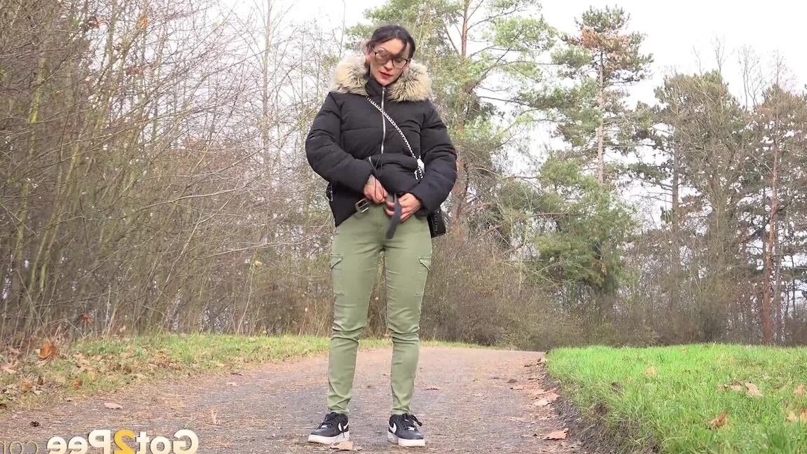 15P Clothed female Natasha Ink holds down her pants for a piss on a rural road
