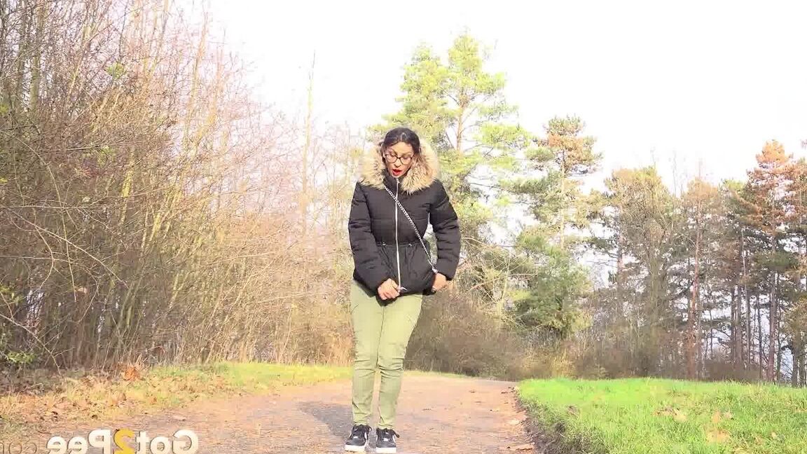 15P Clothed female Natasha Ink holds down her pants for a piss on a rural road