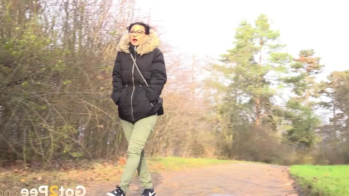 15P Clothed female Natasha Ink holds down her pants for a piss on a rural road