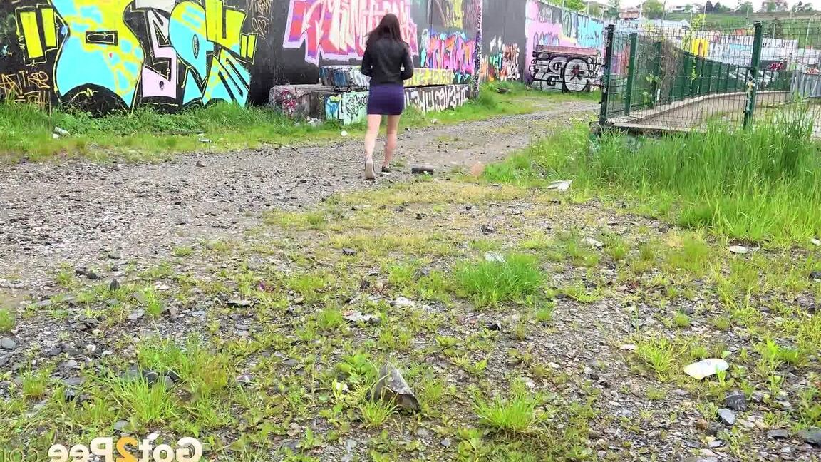 15P Solo girl Victoria Daniels hitches up her miniskirt to pee on a gravel path