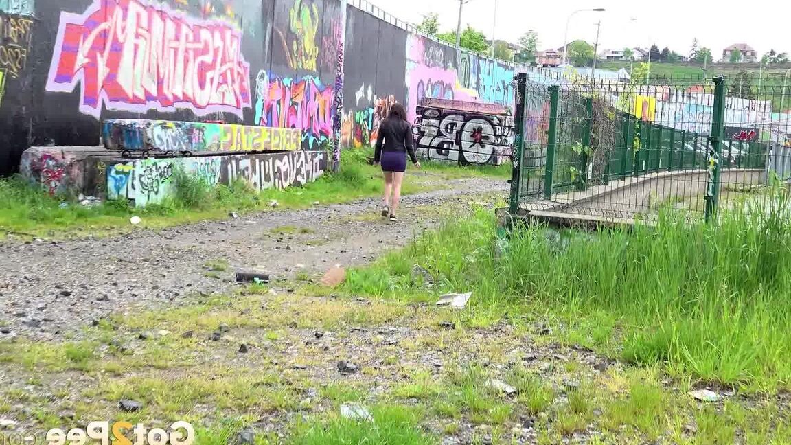 15P Solo girl Victoria Daniels hitches up her miniskirt to pee on a gravel path