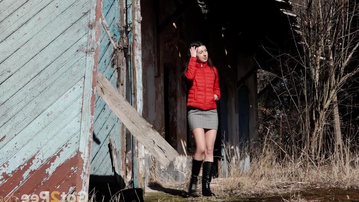 15P Brunette chick Katya squats for a piss behind a building in black boots