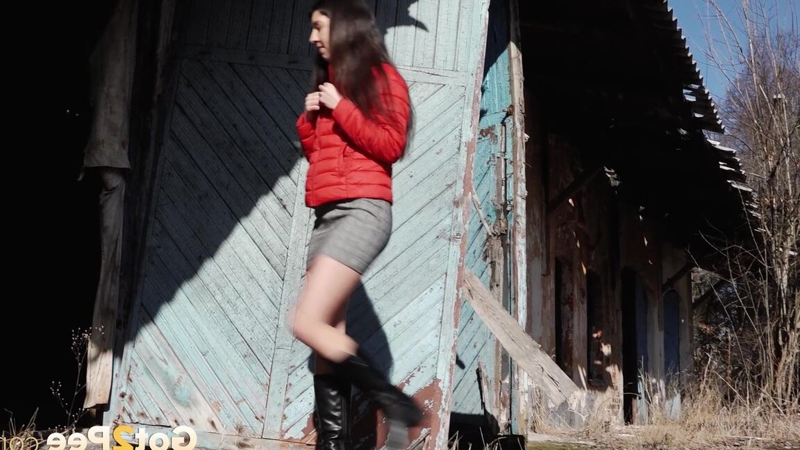 15P Brunette chick Katya squats for a piss behind a building in black boots