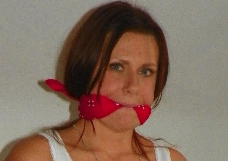 14P Amateur model is hogtied and gagged on a bed while fully clothed