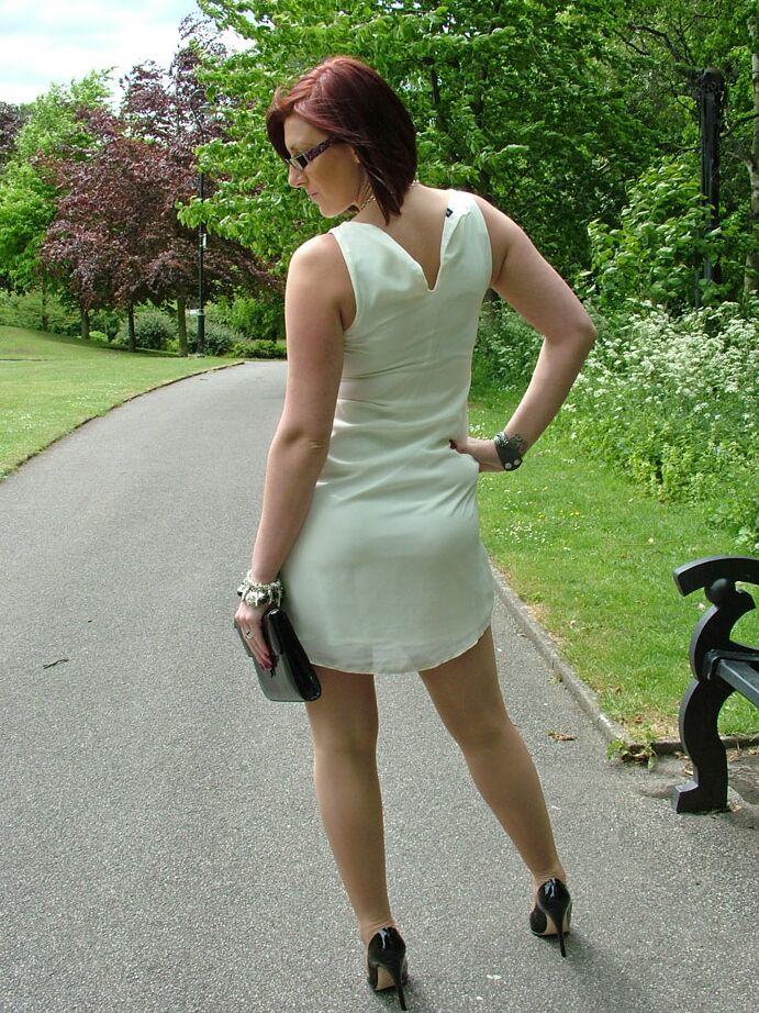 16P Thick woman in glasses shows off her stiletto heels on a park bench