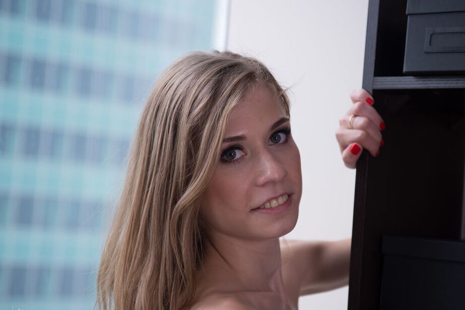 16P Skinny teen Eva Gold wanders about a highrise office with no clothes on