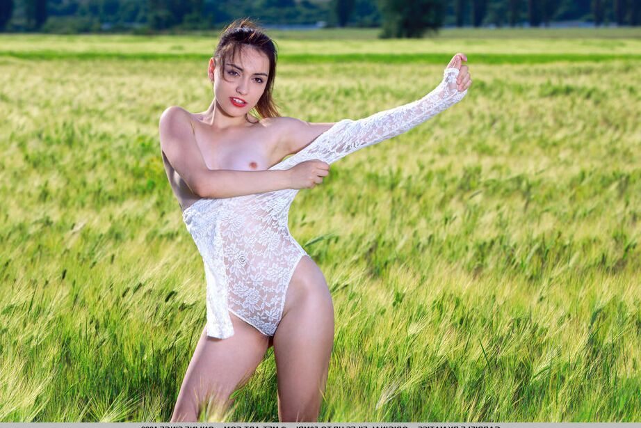 18P Nice young girl Gabriele sports red lips while getting naked in a crop field